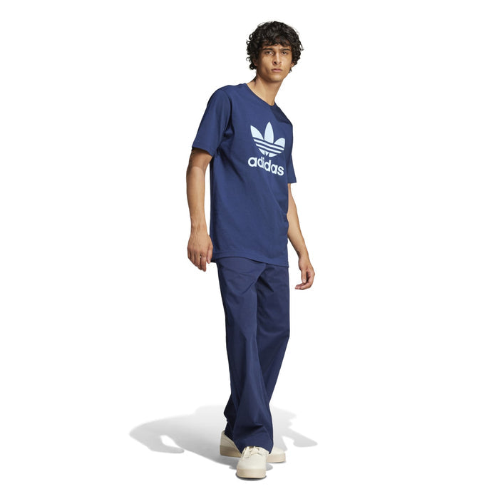 Men's navy trefoil graphic T-shirt with adidas logo, model standing