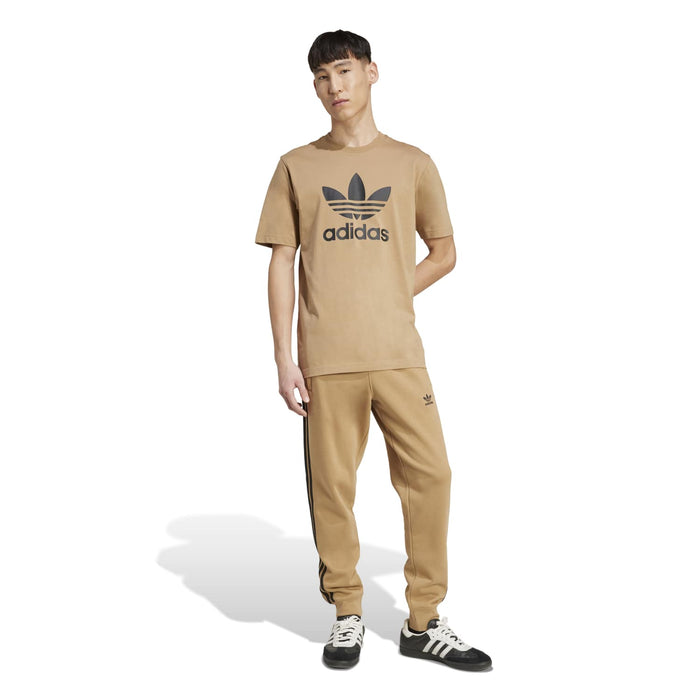Men's tan adidas trefoil logo T-shirt with crew neck, model wearing it
