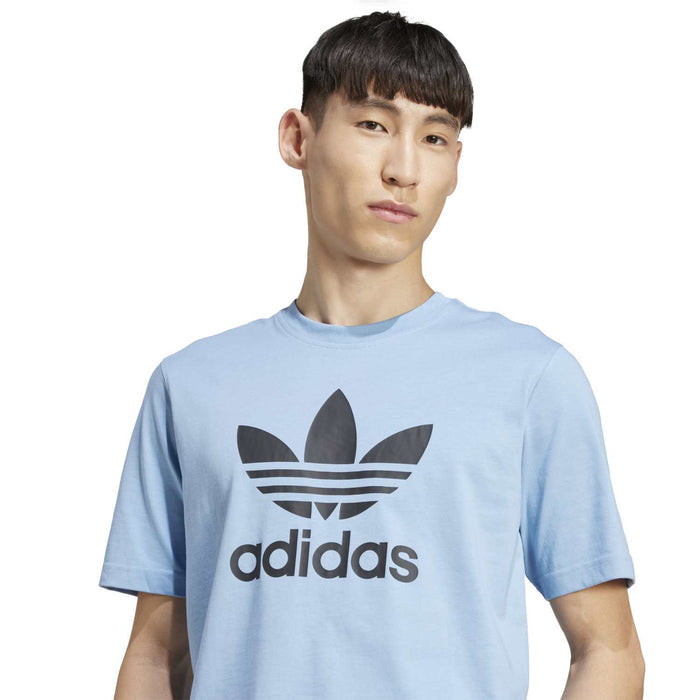 Men's light blue adidas trefoil t-shirt with large chest logo, close-up