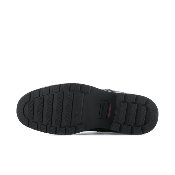 Bottom view of men's black Chelsea boots showing tread pattern