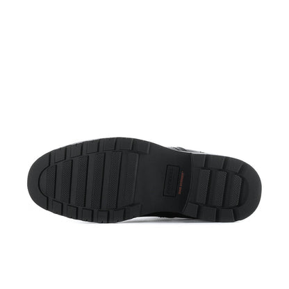 Bottom view of men's black Chelsea boots showing tread pattern