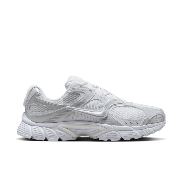White lace-up running sneaker with mesh upper, Swoosh logo, and chunky sole
