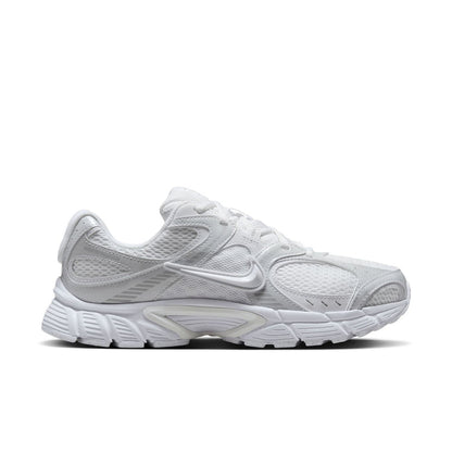 White lace-up running sneaker with mesh upper, Swoosh logo, and chunky sole