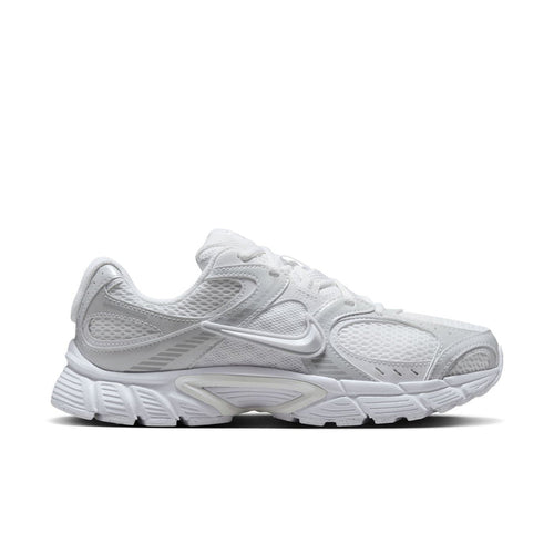White lace-up running sneaker with mesh upper, Swoosh logo, and chunky sole