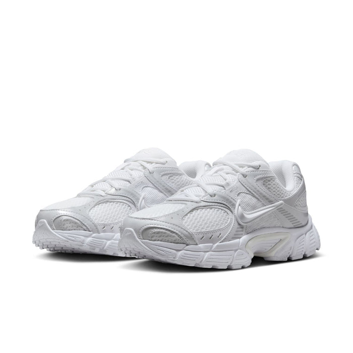 White lace-up running sneakers with mesh panels and layered cushioning sole
