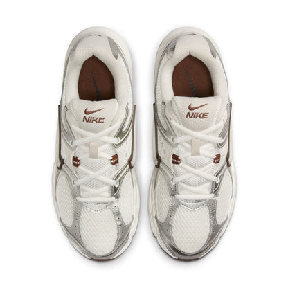 Pair of white Nike sneakers with lace-up closure and brown interior lining.