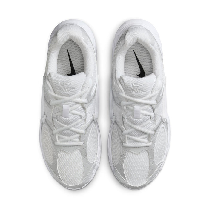Pair of white lace-up sneakers viewed from front, showing laces and Swoosh accents