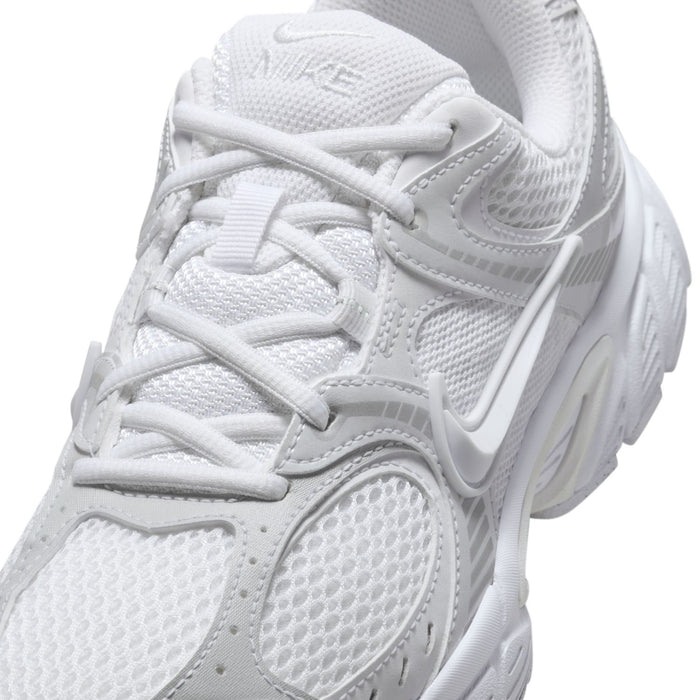 Close-up of white mesh running sneaker upper with laces and Swoosh logo