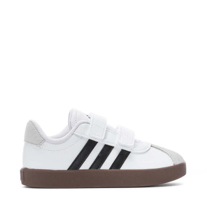 White toddler sneakers with hook-and-loop strap, black stripes and brown rubber sole