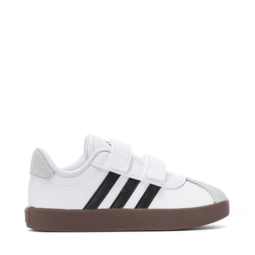 White toddler sneakers with hook-and-loop strap, black stripes and brown rubber sole