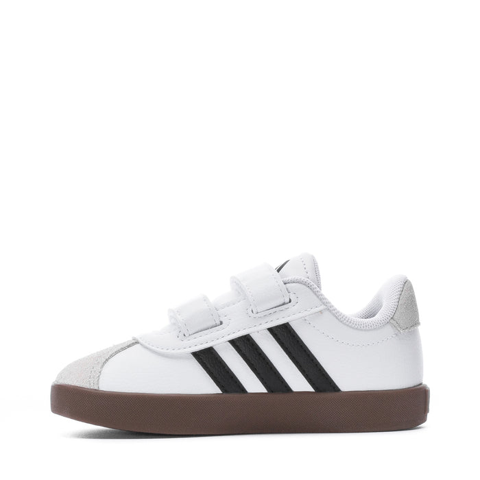 White toddler sneakers with two black side stripes and brown rubber sole, Velcro strap