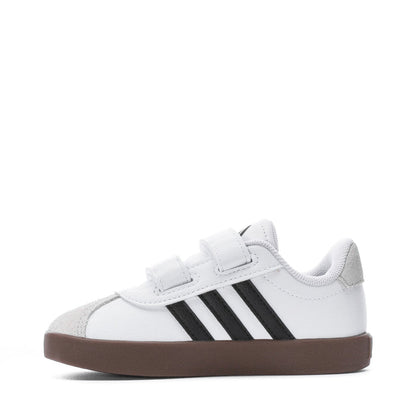 White toddler sneakers with two black side stripes and brown rubber sole, Velcro strap
