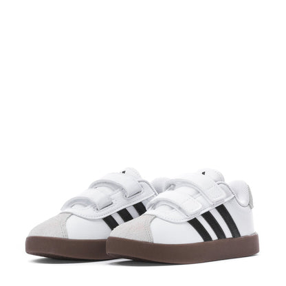Pair of white toddler sneakers with two black stripes and Velcro straps, brown sole