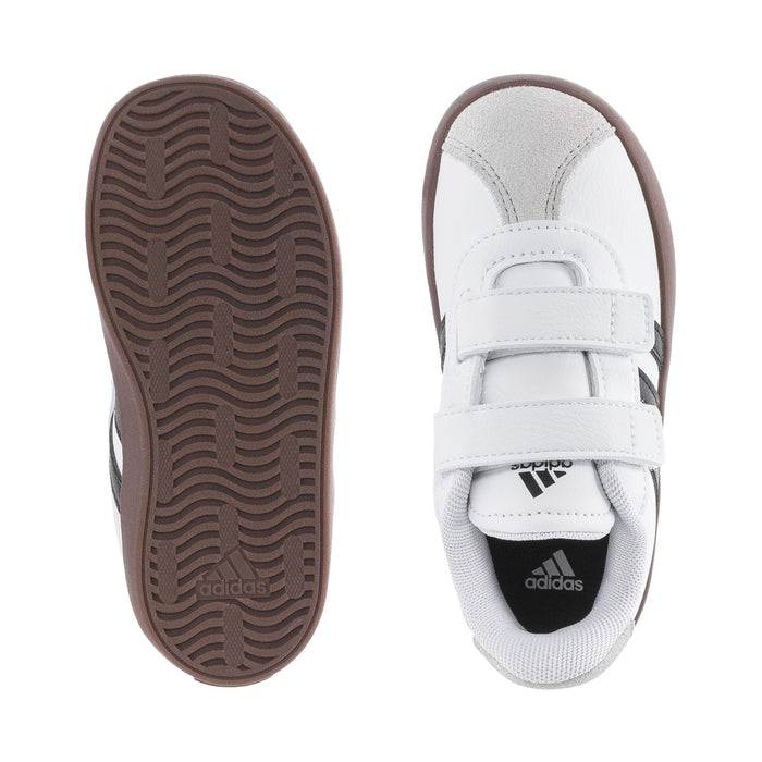 White toddler sneaker with brown outsole view and stitched strap detail, Adidas logo