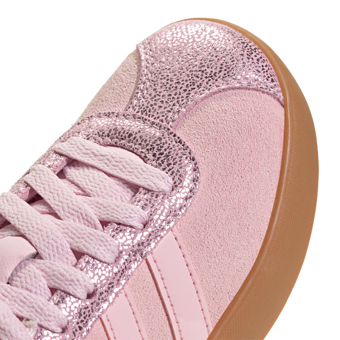 Youth sneaker close-up: light pink lace-up with textured glitter overlays