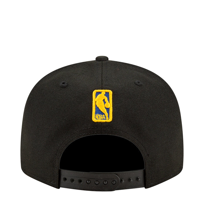 Black baseball cap with yellow on-back badge and ventilated panel holes