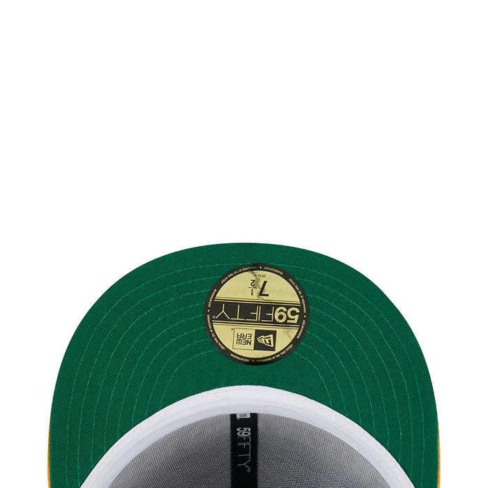 Green satin baseball cap top button with round gold emblem patch and stitching