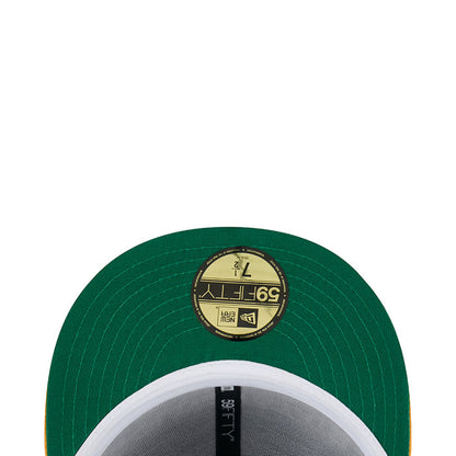 Green satin baseball cap top button with round gold emblem patch and stitching
