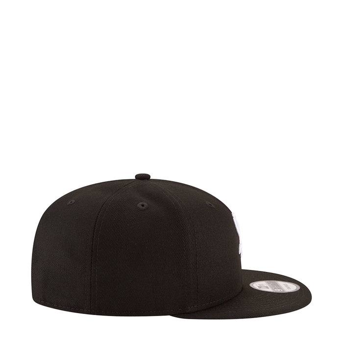 Black baseball cap with curved brim and top button, side view