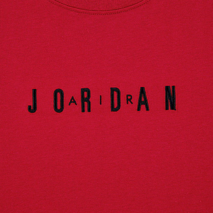 Close-up of embroidered "JORDAN" wordmark on Gym Red T-shirt front