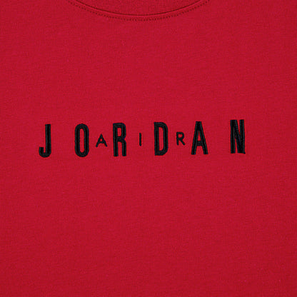 Close-up of embroidered "JORDAN" wordmark on Gym Red T-shirt front