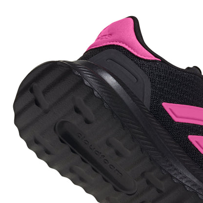 Youth black sneaker outsole view with pink heel collar and tread pattern