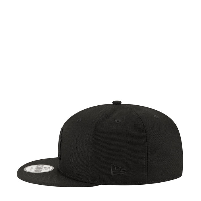 Black baseball cap with small side emblem and curved brim