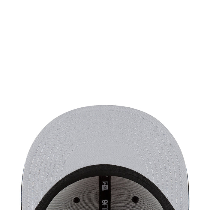 Light gray/white baseball cap close-up with black inner band and tag