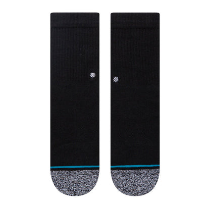 Pair of black crew socks, gray footbed, blue stripe, small white logo on back.